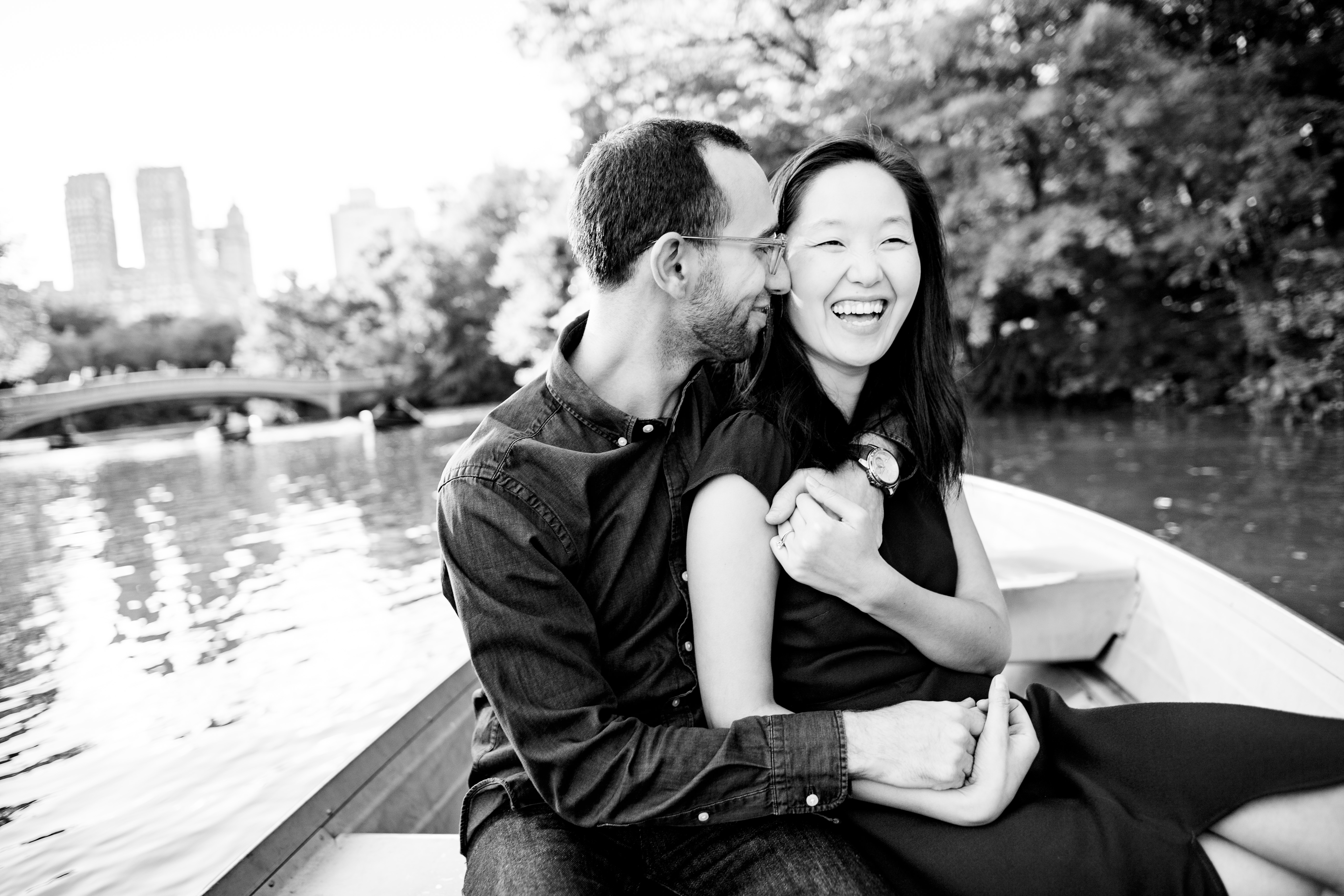 Engagement — couple laughing on rowboat
