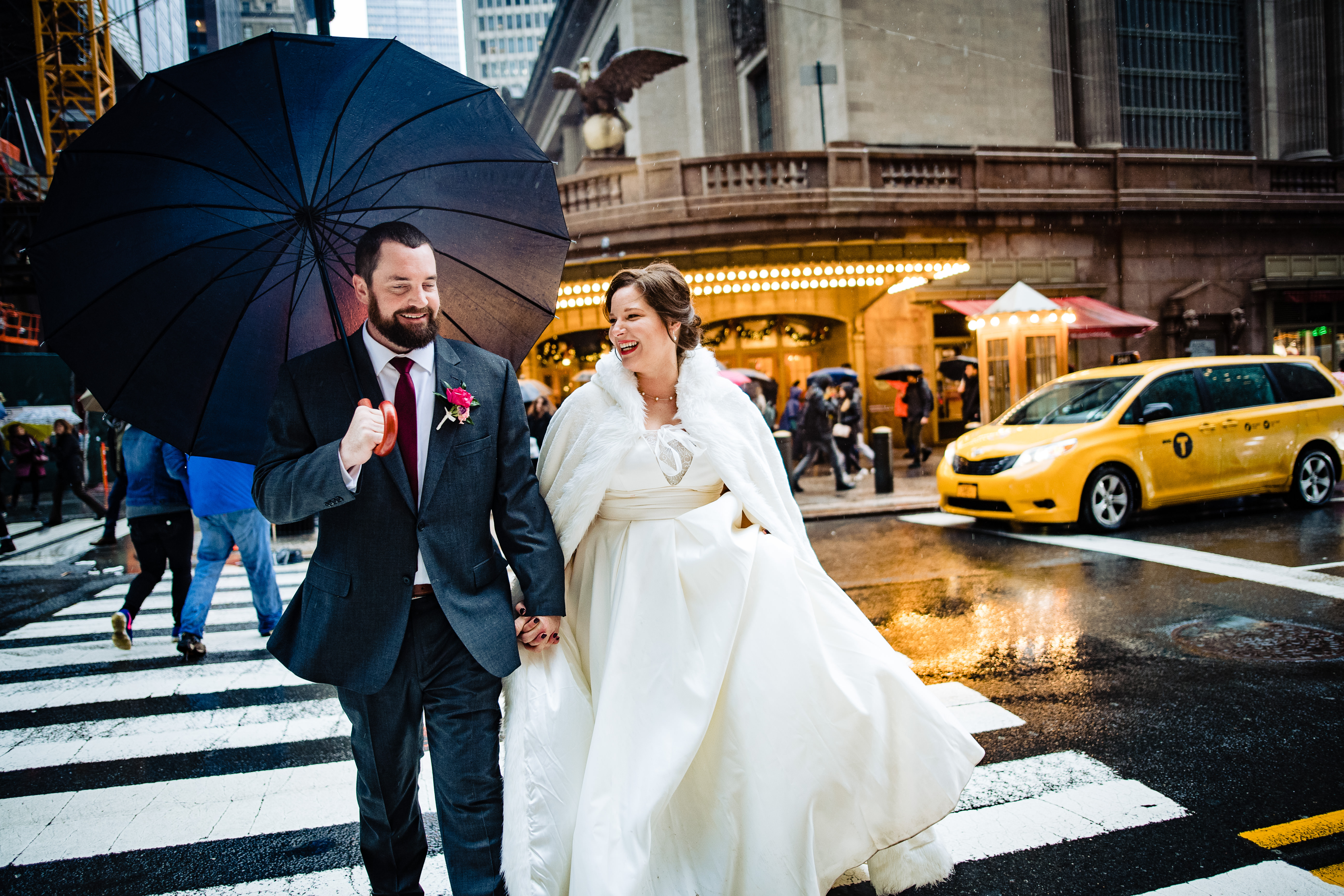 Couple walking in rain near Grand Central